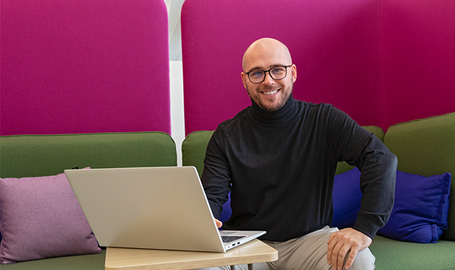 Glücklicher Mitarbeiter am Laptop